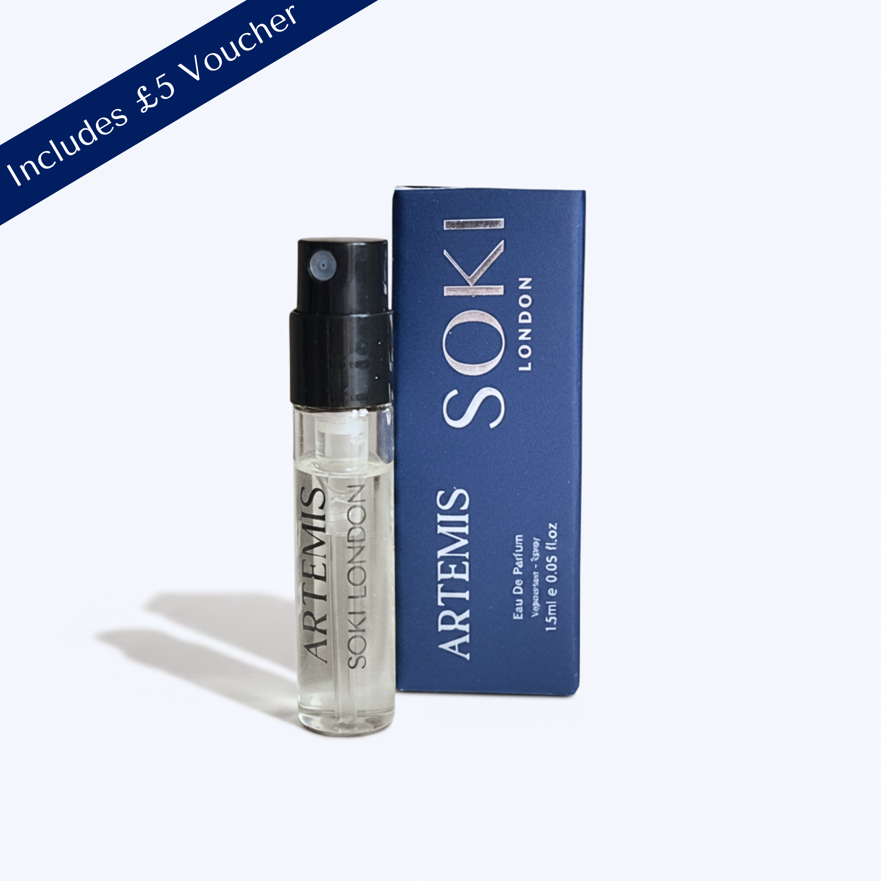 A small Artemis Soki London perfume sample bottle with a black spray top stands next to its blue box on a light gray background. A blue diagonal banner in the top-left corner reads 'Includes £5 Voucher'.